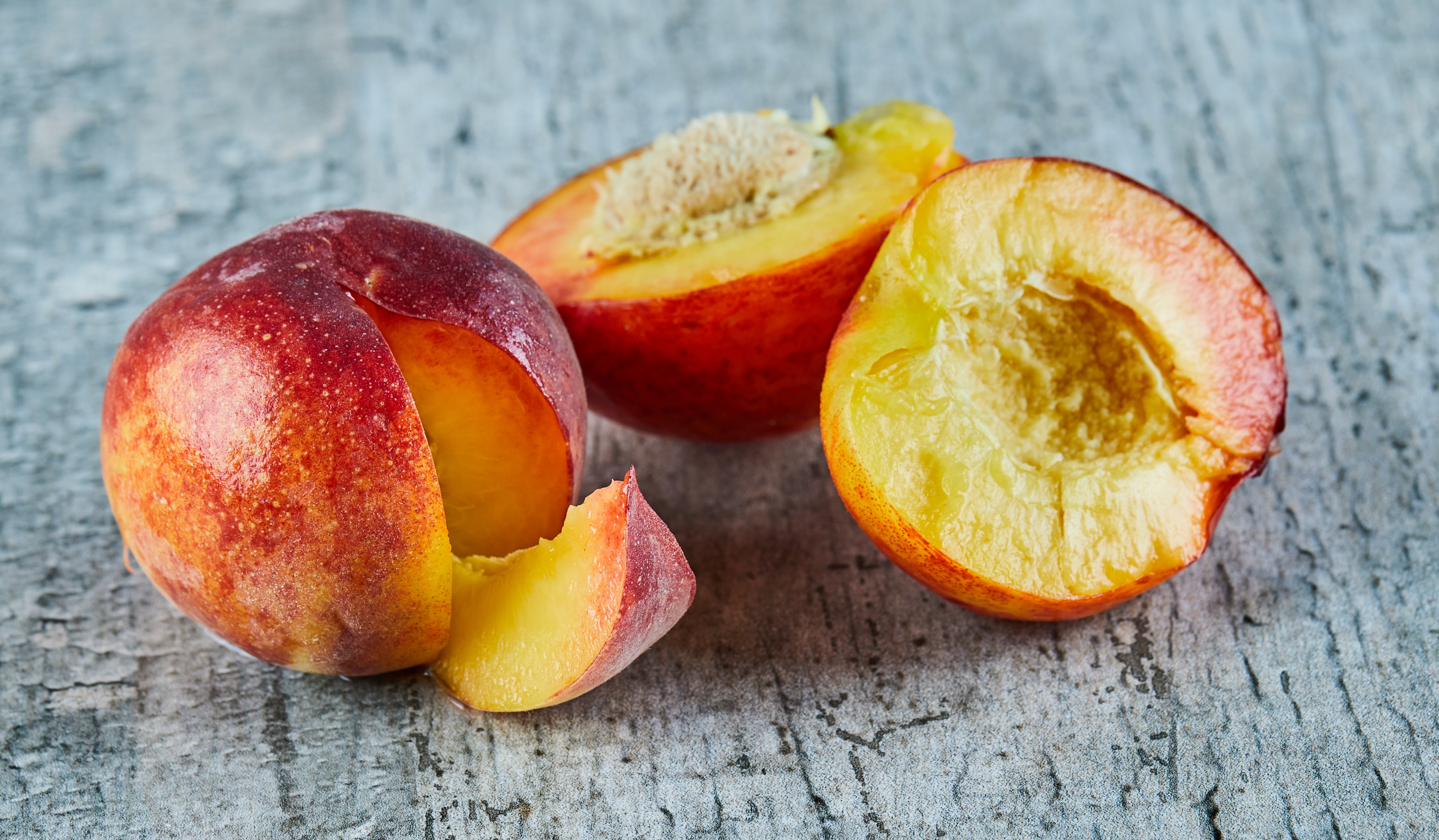 Cut ripe nectarines on marble background